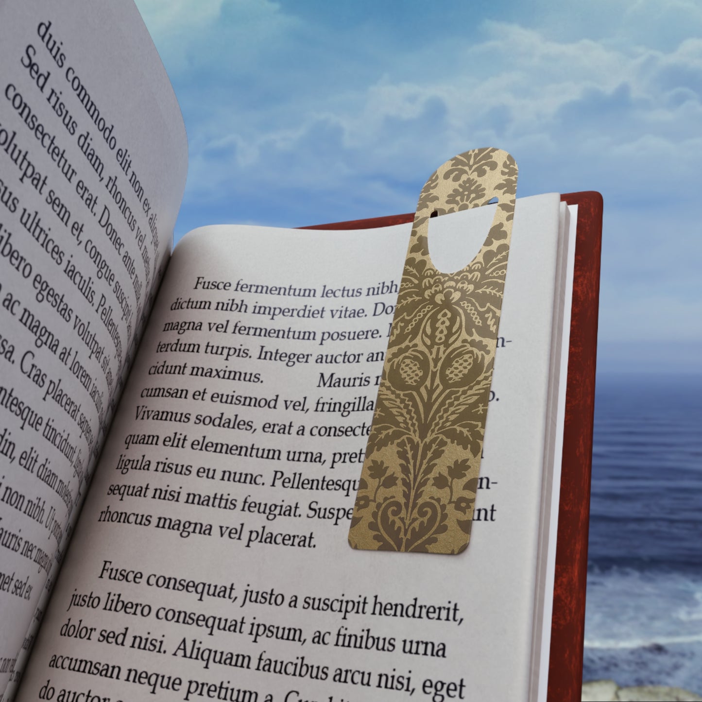 Open book with a decorative bookmark against a scenic background