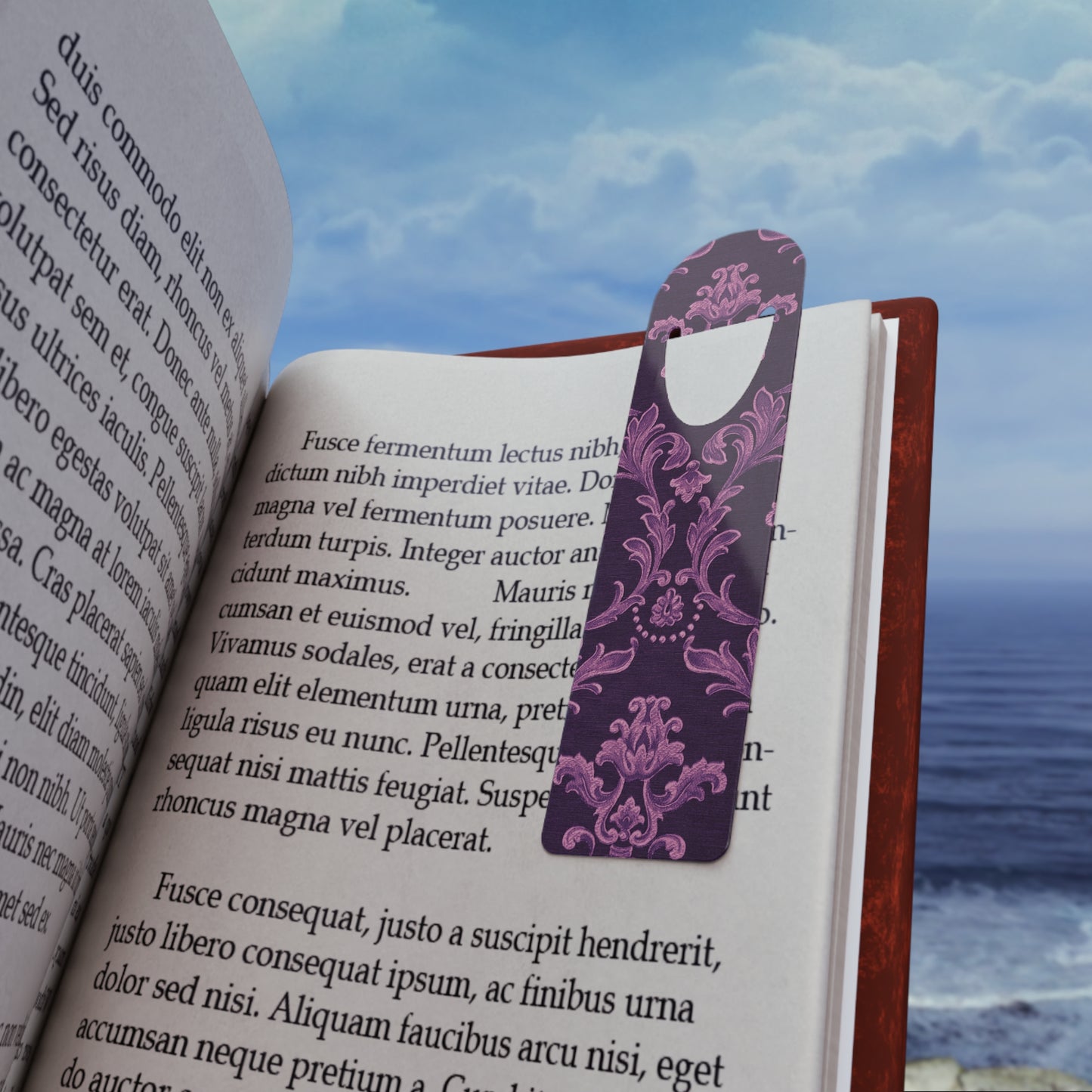 Open book with a purple floral bookmark against a scenic background
