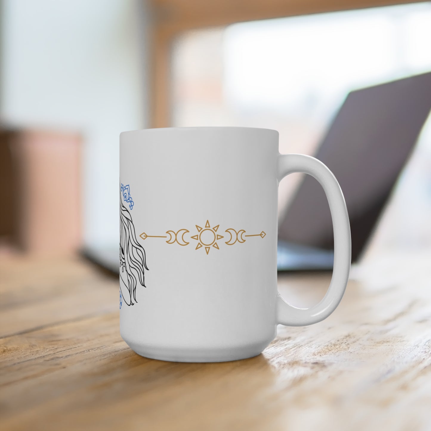 White mug with decorative designs on a wooden surface
