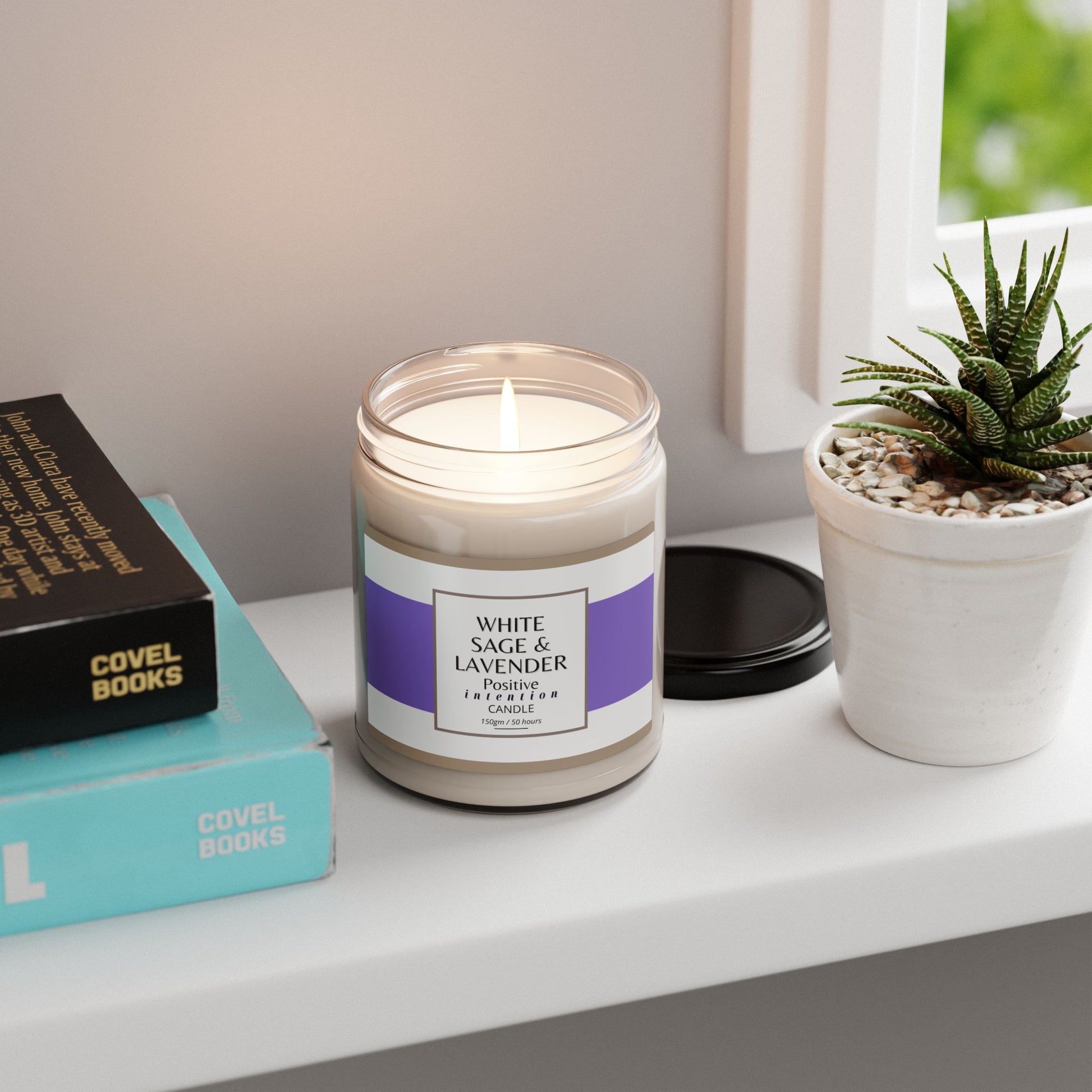 Candle with a purple label on a shelf next to books and a plant